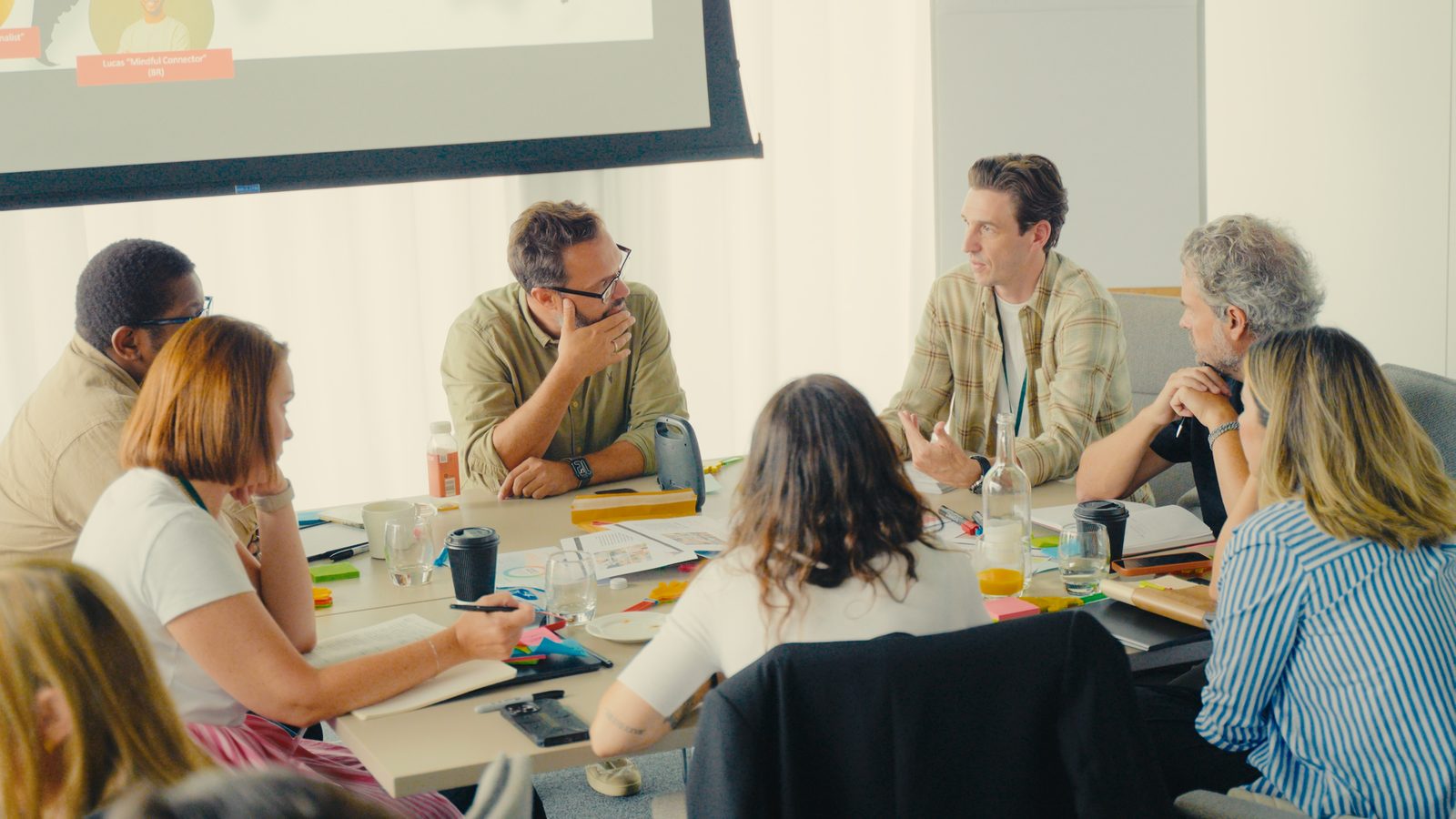 A REBORRN working session: a mixed client and REBORRN team around a table, mid-discussion